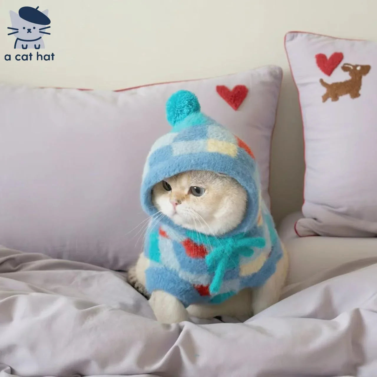 Suéter de gato con capucha y pompones con estampado de rombos